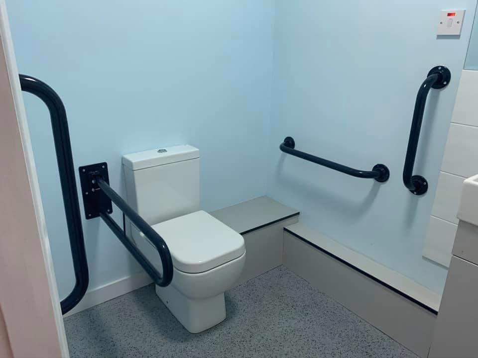 toilet with hand rails